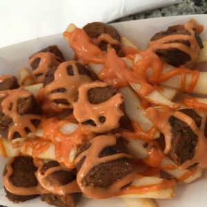 Vegan Salchipapas! (french fries topped with vegan hot dog slices and Simon's sauce) at Simon's Hot Dogs in Scottsdale