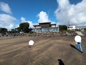 At the beach looking back at the Cafe at Bach on Breakwater in New Plymouth