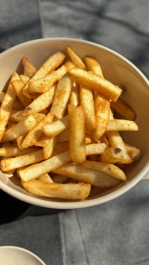 Smoky fries. On a green plate which the plant based paradise market at fed square   at Woking Amazing in Northcote