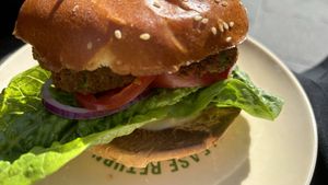 Mint + pea patties on a burger. It was really tasty. Served on a green plate which the plant based paradise market at fed square   at Woking Amazing in Northcote
