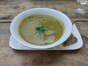 Spinach soup with half a slice of bread at GustaV in Salzburg