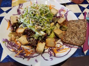 Salad with smoked cashew cheese, gluten-free bread, sprouts, pumpkin seeds, sunflower seeds, carrots, cabbage at GustaV in Salzburg