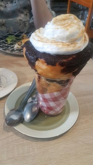 Chocolate coated donut with ice cream, topped with toasted marshmallow fluff at Sweet Release in Wellington