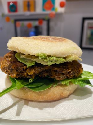 Vegan-friendly breakfast sandwich featuring house-made "sausage" , avocado, vegan mayo & spinach on a toasted English muffin at Cafe Oranje in Hamilton