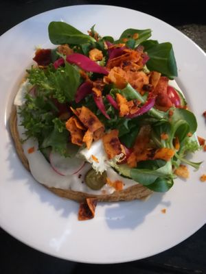 Chickpea omelet with mayonnaise, salad & coconut-based bacon on top at Cafe Michelle in Warsaw