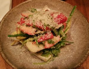 Endive, strawberries, and pea pod slices in salad with grated macadamia nuts at Miss Kaplan in Tel Aviv