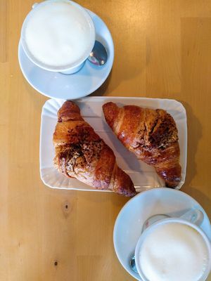 Two croissants filled with chocolate and cappuccino with soy milk. at Pasticceria Caffetteria Larocca in Busto Arsizio
