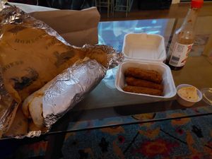 Giant burrito and mozzarella sticks. My bottle of tapatio. at Homegrown Smoker in Portland
