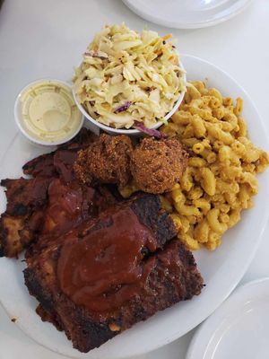 Platter with ribs, smoked chicken, coleslaw, Mac n cheese, and hush puppies at Homegrown Smoker in Portland