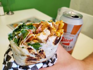 Buff Burrito with smoked chick'n, mac and cheese, tempeh bacon, buffalo sauce, ranch dressing, peppers, onions, cheese, tomato, and greens. Photo taken May 2019. at Homegrown Smoker in Portland