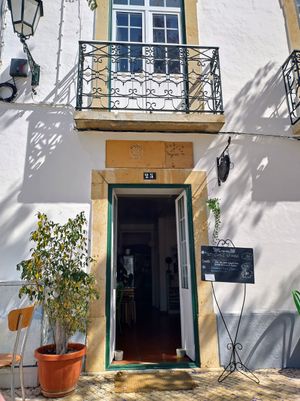 Outside facing the fountain on the square at Alcachofra Cafe in Faro