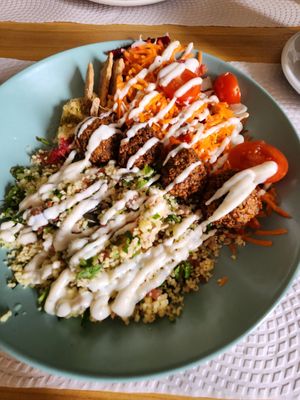 Couscous bowl with grated carrot and beet salad and falafel at Alcachofra Cafe in Faro
