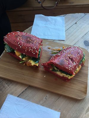 Avo, cheese n spinach toastie in beetroot bun at Love Your Soul in Parkdale