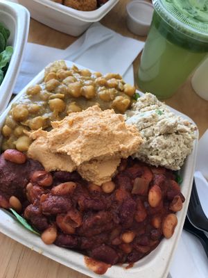 super hero sampler with bean chili, chickpea masala, veggie tuna, black bean ball on a bed of spinach and quinoa. green advanced juice on the side at Plant Wise in Dix Hills