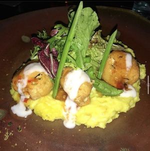 Zucchini tofu balls on a bed of mashed cassava  at Moksa in Ubud