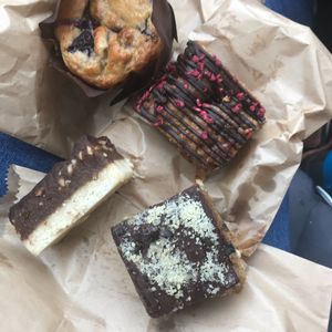 Blueberry and banana muffin, raspberry and chickpea blondie, caramel slice, s’nickers slice (starting at top clockwise). at Sweet Beat Cafe in Sligo