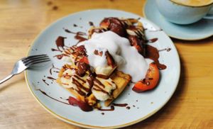Waffles with dark chocolate sauce, banana, plums and coconut yogurt at Copperhouse Chocolate in North London