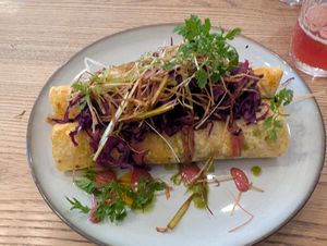 Potato pancakes stuffed with celery confit and smoked tofu, black lentils, cashew ricotta, plum emulsion, marinated cabbage, leek straw, paprika and parsley oil, pickled onions at Pastva in Prague