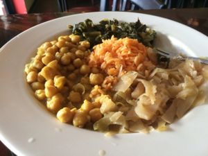 Large chickpea curry with greens, cabbage and yellow rice.  at Island Krave in Norfolk