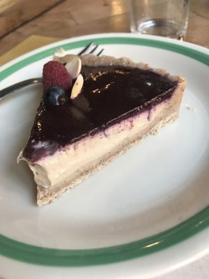 Delicious dessert!  Almond crust, cashew cream Center with blueberry purée top. at Ecru in Rome