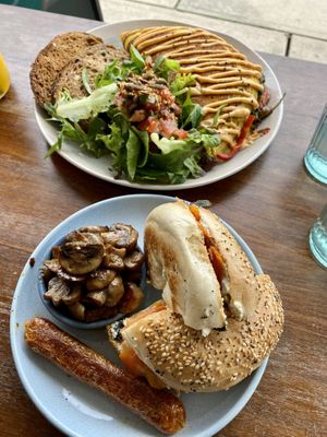 Vegan omelette and lox bagel with side of mushrooms and sausage  at Herb & Sprout Co in Maroubra