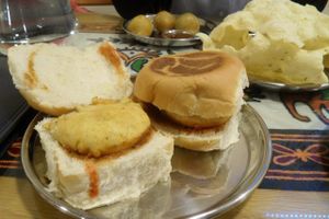 Muttary Kachori on the back (crispy pastry balls with spiced peas inside), Home-made rice poppadom, Bombay Wada Pav (sandwich with potato burger) at Vegetarian Food Studio in Cardiff