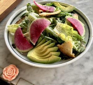Little Gem Caesar salad with watermelon radish, avocado, and sourdough croutons at Kindred in San Diego