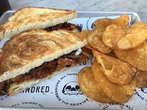 Kindred BBQ jackfruit sandwich with homemade potato chips at Kindred in San Diego