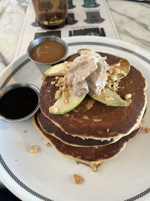 Pancakes: Bourbon Butterscotch & syrup on side, Caramelized Apple, Toasted Peanuts, & Whipped Coconut Cream  at Kindred in San Diego