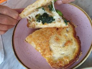 Mind Melt - sourdough grilled cheese, bechamel, kale, French onions, apples, spicy (rice-based) honey at Kindred in San Diego