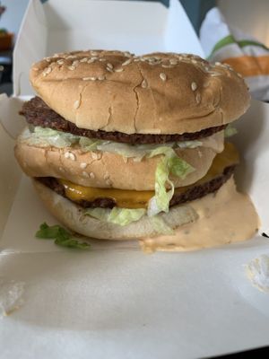 Big Zac Burger (two sizzled ‘beefy’ patties, American ’cheese’, shredded lettuce, diced raw onions, pickles, and a special sauce at Plant Power Fast Food - Ocean Beach in San Diego