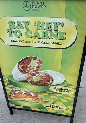 Sign outside for comparison to the real thing   at Plant Power Fast Food - Ocean Beach in San Diego