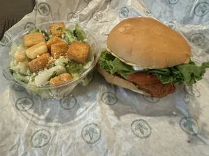 Chicken burger and side Caesar salad  at Plant Power Fast Food - Ocean Beach in San Diego