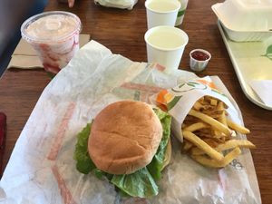Crispy chicken sandwich, fries and strawberry milkshake. Very American yet very vegan.  at Plant Power Fast Food - Ocean Beach in San Diego