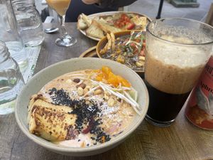Shoyu Ramen with tofu, beer poured Clinton style, Vegan Poutine, Mushroom Ravioli  at Nourish Bistro in Banff