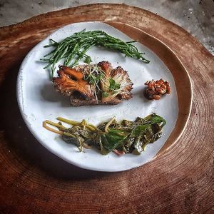 Roasted maitake mushroom or also known as hen of the woods not be confused for chicken of the woods as that's a totally different mushroom, with seared samphire and locally foraged at Trewhitts in Bristol