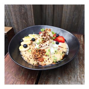 ANCIENT GRAIN PORRIDGE 
A nourishing mix of quinoa, brown rice, buckwheat grouts and coconut shreds simmered in our creamy house made cashew mylk, topped with pure maple syrup, cocowhip, roasted nuts & seeds, banana slices and berries. at Island Whole Foods in Cowes