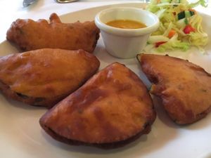 Kathrika - Finely sliced pieces of aubergines are dipped in a special batter, blended with coriander and chilly, before frying. Served with fresh tomato chutney.   at Dinithi Restaurant Ury in Newcastle Upon Tyne