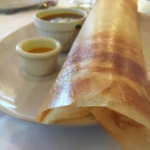 MASALA DOSA -  A paper thin pancake made of rice and black gram,folded in half with a filling of spicy potatoes cooked with onions and ginger and served with sambar and coconut chutney. at Dinithi Restaurant Ury in Newcastle Upon Tyne