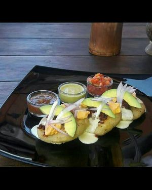 Gorditas de Frijol con Chorizo de Garbanzo, Crema, Queso y Salsas at Mito  in Zihuatanejo