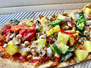 Vegan pizza! ⭐️ Lots of veggies, vegan cheese, spicy chickpeas, vegan beef and pineapple   at IAD - &pizza - CC in Dulles