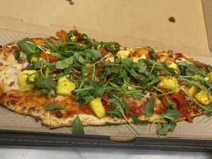 DIY pizza with Red sauce, Vegan cheese, vegan sausage, pineapple, jalapeño, roasted red peppers, and arugula.  at IAD - &pizza - CC in Dulles