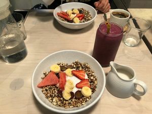 Breakfast with roasted cereals, macadamia, fruit and coconut yogurt + coconut milk at Hunters' Roots in Melbourne