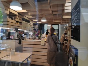 Cute interior, A few small tables and bench with stools at Hunters' Roots in Melbourne