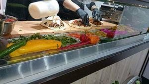 Pouring Tahini dressing sauce at Falafel Bejrut - Nowolipki in Warsaw