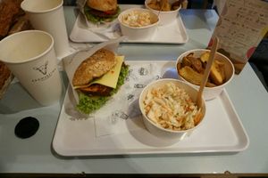 Menu with burger, fries and coleslaw at Krowarzywa in Krakow