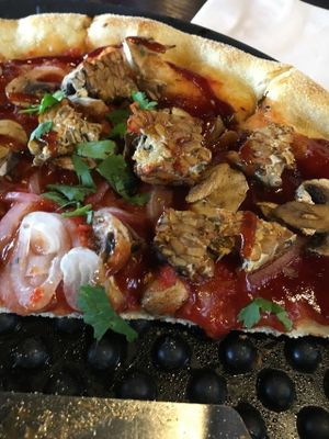 BBQ Tempeh Pizza with no cheese and vegan tomato sauce. They now have a vegan cheese option. Very delicious at Blue Highway Pizza in Ocala