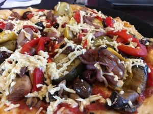 Roasted vegetable pizza with vegan pizzas sauce, mushrooms, kalamata olives, and vegan cheese. Delicious!!! at Blue Highway Pizza in Ocala
