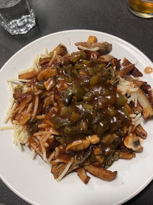 Vegan poutine with classic gravy, vegan cheese, jalapeños and green peppers  at Poutineville in Quebec