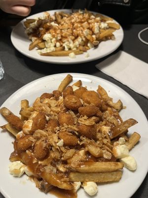 Gravy is vegetarian. Classic poutine on the back, Crispy poutine on the front. Vegetarian, not vegan.   at Poutineville in Quebec
